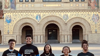 Five students in front of building