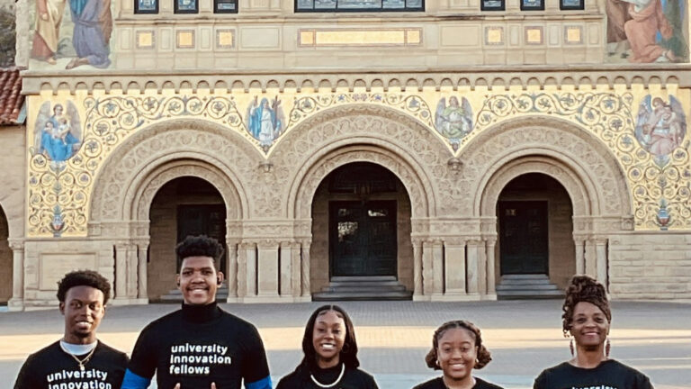 Five students in front of building
